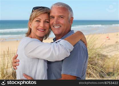 senior couple on vacation embracing