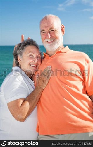 Senior couple on vacation. He&rsquo;s goofing around and giving her rabbit ears.