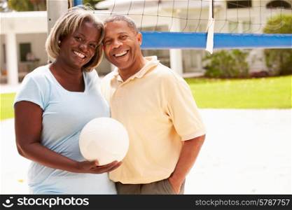 Senior Couple Playing Volleyball Together