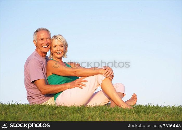 Senior couple posing on a field