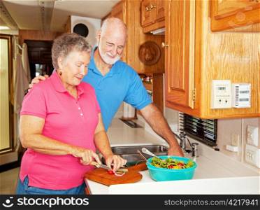 Senior couple preparing a healthy lunch in their motor home kitchen