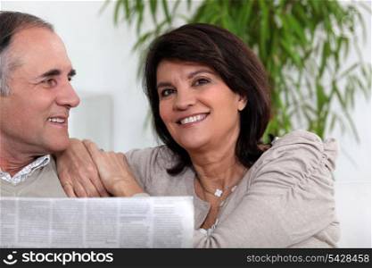 Senior couple reading the newspaper
