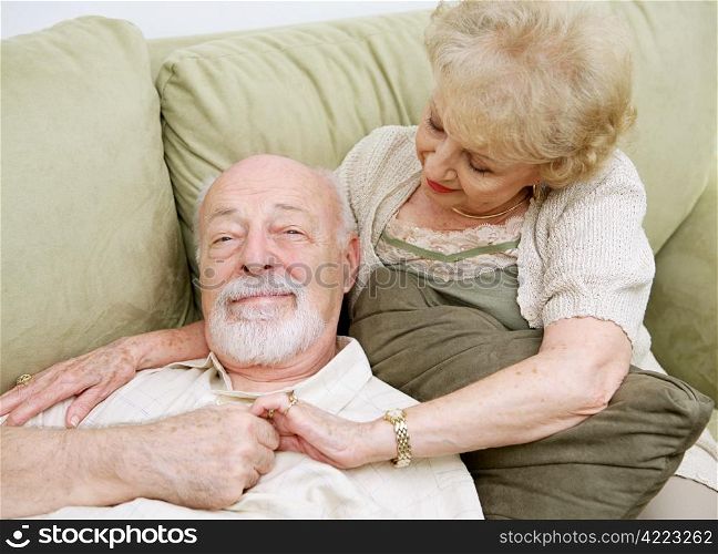 Senior couple relaxing at home on the couch together.