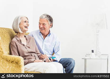 Senior couple relaxing at home, smiling