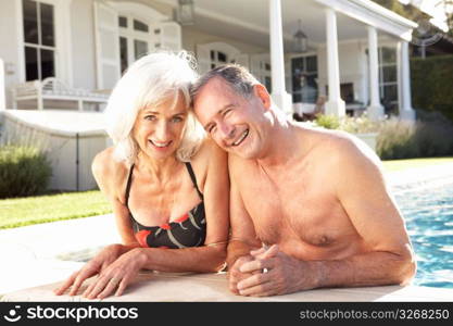 Senior Couple Relaxing by Outdoor Pool