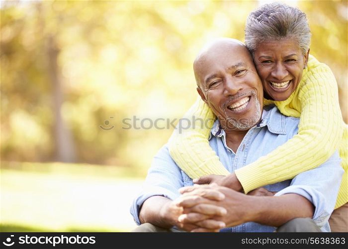 Senior Couple Relaxing In Autumn Landscape