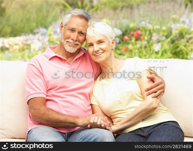 Senior Couple Relaxing In Garden