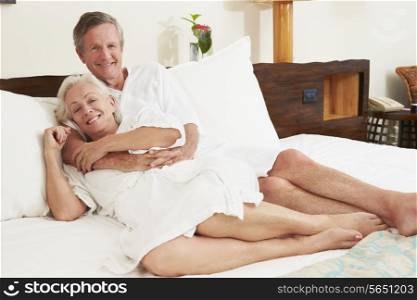 Senior Couple Relaxing In Hotel Room Wearing Robes