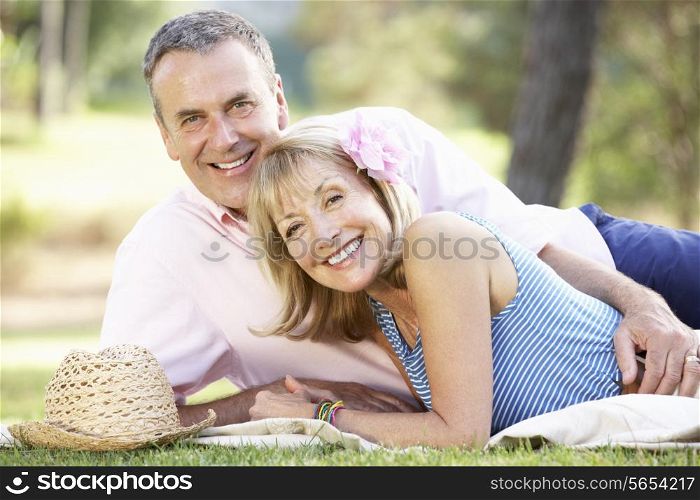 Senior Couple Relaxing In Summer Garden