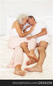 Senior Couple Relaxing On Bed