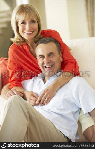 Senior Couple Relaxing On Sofa At Home
