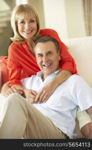 Senior Couple Relaxing On Sofa At Home