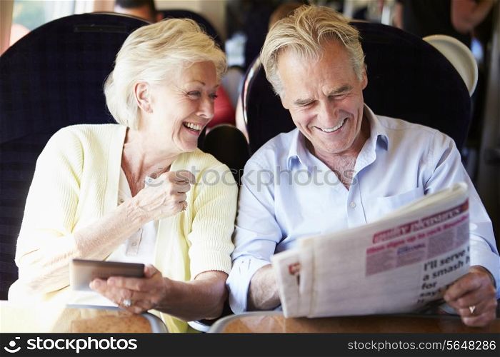 Senior Couple Relaxing On Train Journey