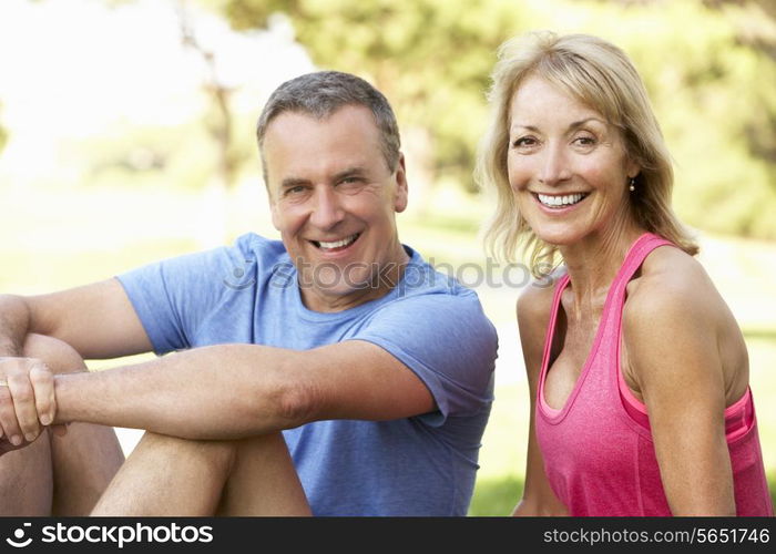 Senior Couple Resting After Exercising In Park