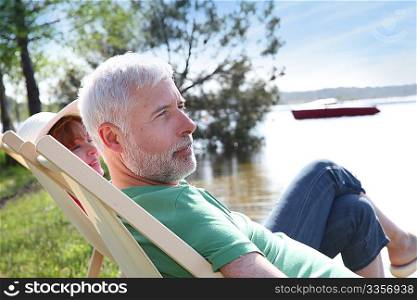 Senior couple resting in deck chair