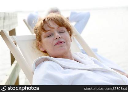 Senior couple resting in deckchairs