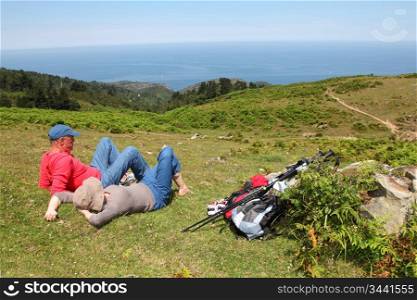 Senior couple resting in meadow on a sunny day