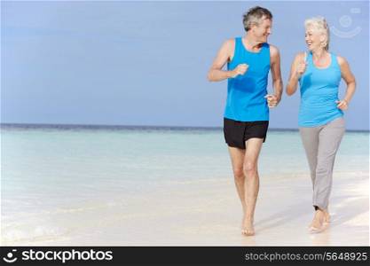Senior Couple Running On Beautiful Beach