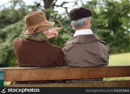 senior couple seated on a park bench