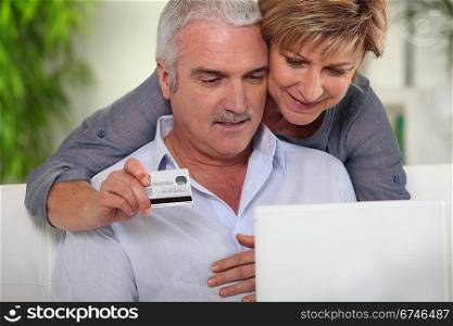 senior couple shopping on Internet