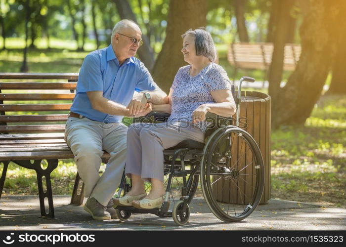 Senior couple shopping online using credit card on laptop