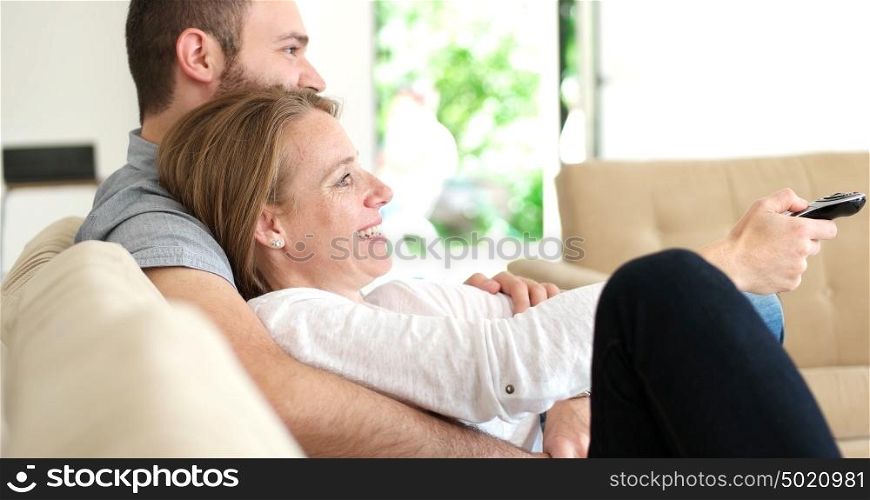 Senior couple sitting in couch and watching tv