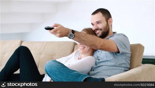Senior couple sitting in couch and watching tv
