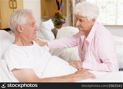 Senior Couple Sitting In Hospital
