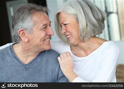 Senior couple sitting in sofa at home