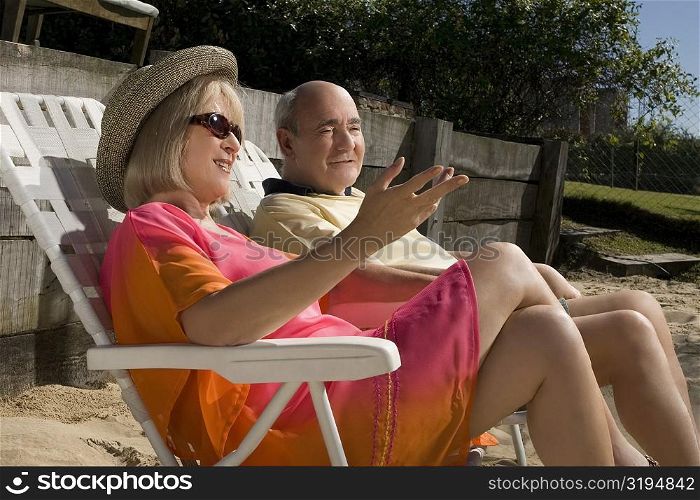 Senior couple sitting on chairs