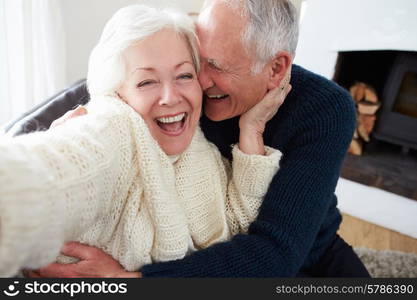 Senior Couple Sitting On Sofa And Relaxing