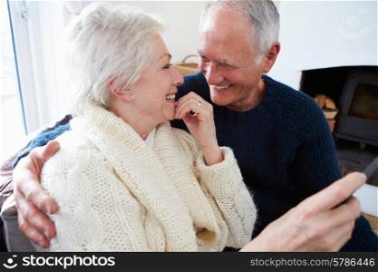 Senior Couple Sitting On Sofa And Relaxing