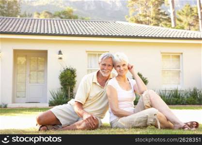 Senior Couple sitting Outside Dream Home