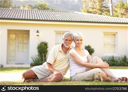 Senior Couple sitting Outside Dream Home