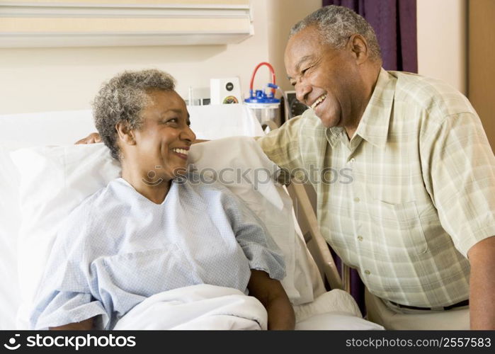 Senior Couple Smiling At Each Other In Hospital