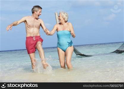 Senior Couple Splashing In Beautiful Tropical Sea