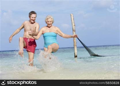 Senior Couple Splashing In Beautiful Tropical Sea