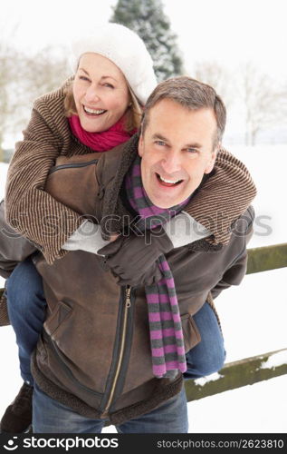 Senior Couple Standing Outside In Snowy Landscape