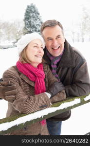 Senior Couple Standing Outside In Snowy Landscape