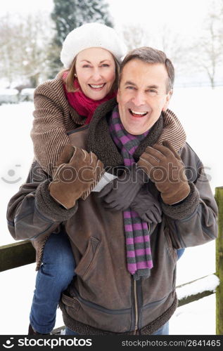 Senior Couple Standing Outside In Snowy Landscape
