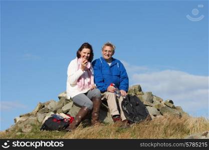 Senior Couple Stopping For Lunch On Countryside Walk