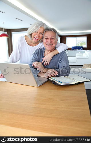 Senior couple surfing on internet at home