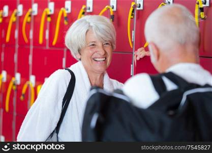 senior couple talking in fitness locker room