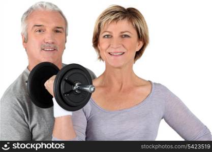 senior couple training in gym