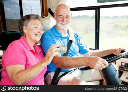 Senior couple using GPS to navigate their vacation motor home.