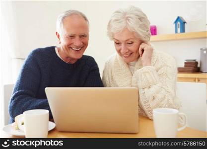 Senior Couple Using Laptop To Shop Online