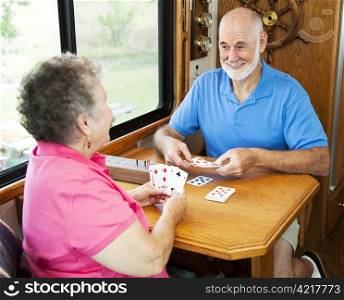 Senior couple vacationing in their motor home, playing a game of cribbage.