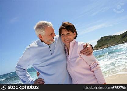 Senior couple walking along the beach