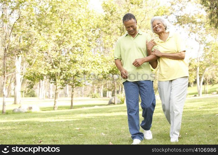 Senior Couple Walking In Park