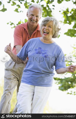 Senior couple walking in park together